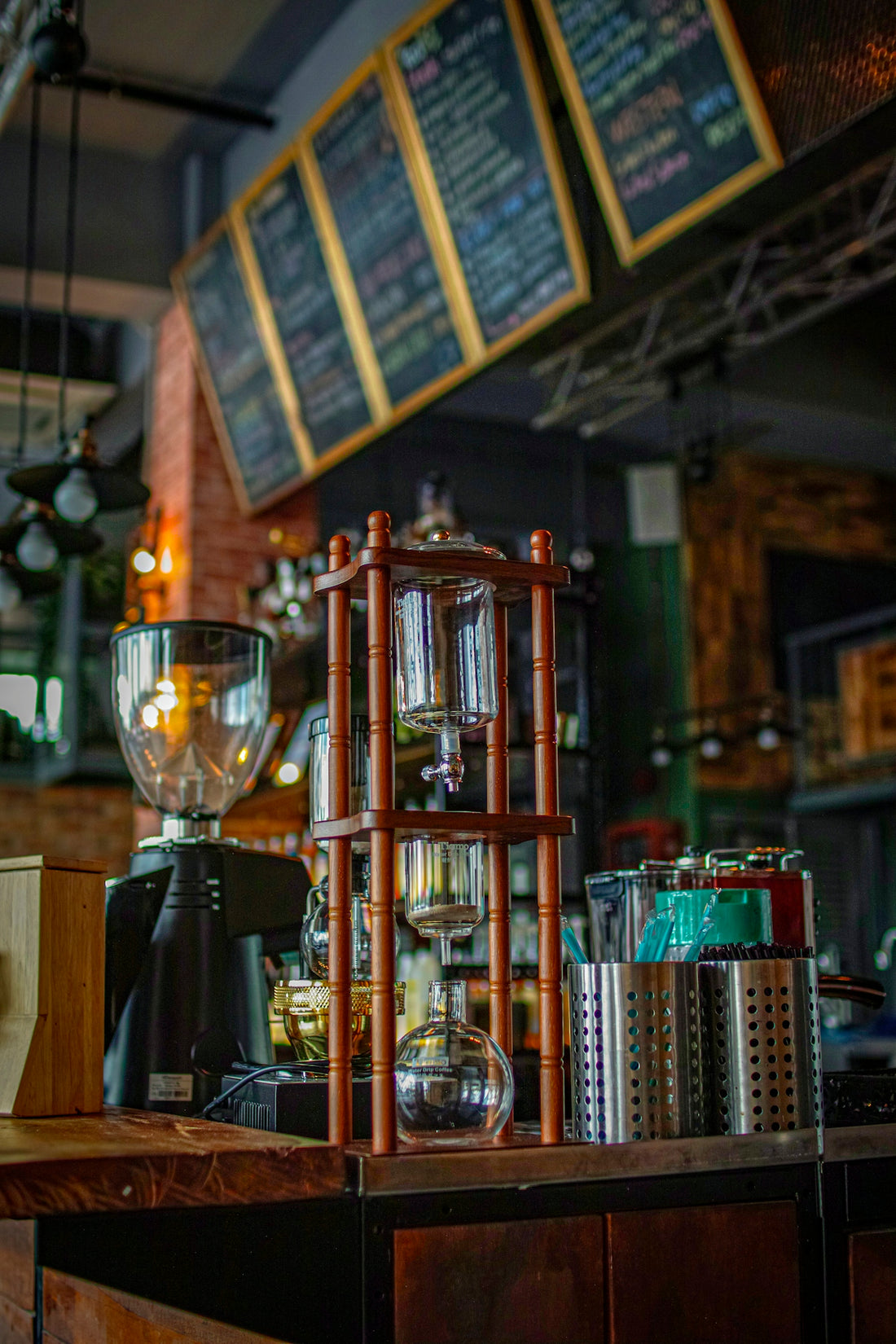 Cold brew coffee maker and grinder in cafe.